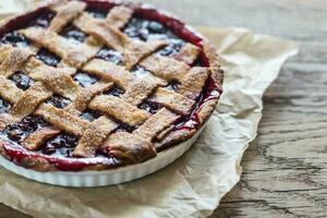Cherry pie on the wooden background photo