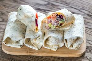 Chicken burritos on the wooden background photo