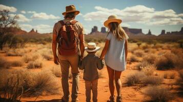 Back view of happy family hiking in Monument Valley on a sunny day, Utah, USA. photo