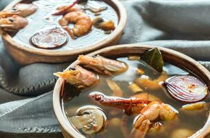 Two bowls of thai tom yum soup photo