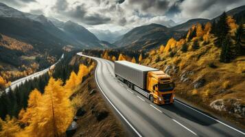 Aerial view of truck on the road in autumn highway. photo