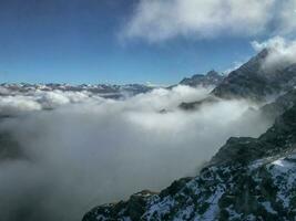 Mountain landscape with clouds and fog on the top of the hill photo