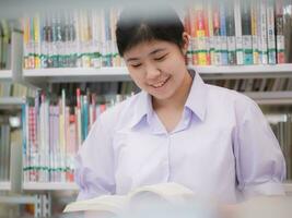 Portrait Asian students studying in the library at university. University students. Education, Student, People concept, uniform photo