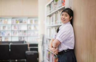 Portrait Asian students studying in the library at university. University students. Education, Student, People concept, uniform photo