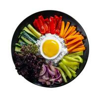 Close-up of Korean dish, isolate, variety of appetizers with vegetables and eggs. Diet. bibimbap. Top view. Round plate. photo