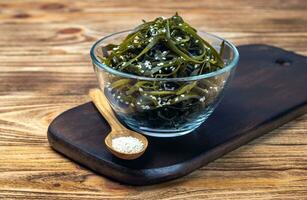 Seaweed salad. Asian cuisine. Seaweed kelp sprinkled with sesame seeds, soft focus. Laminaria photo