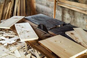 Circular machine with many different wooden blanks and boards. old rustic carpenter's workshop. photo