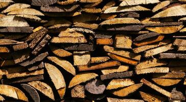 Creative background of neatly stacked firewood. Brown texture of natural wood. Detail, close. Background of cut logs photo