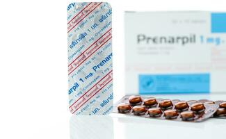 CHONBURI, THAILAND-JULY 11, 2023 Prenarpil tablet pills in brown blister pack. Clonazepam used to treat seizures, panic disorder, anxiety disorders. Benzodiazepines drug. Mental illness medication. photo