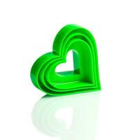 Plastic mold of green color for cutting out heart cookies on a white background, different sizes. Valentine's day baked goods. set of three. Isolate. Close-up photo