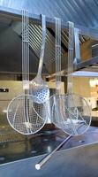 Hanging kitchen utensils cooking tools for a restaurant - scoop, drushlak. photo