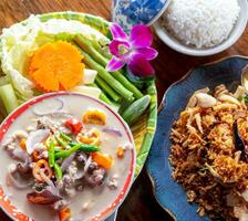 Top view of salted crab dip with coconut milk and vegetables in Thai luxury restaurant. Thai cuisine. Luxury dining experience. Healthy salted crab dip with fresh vegetables. Traditional Thai gourmet. photo