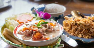 Top view of salted crab dip with coconut milk and vegetables in Thai luxury restaurant. Thai cuisine. Luxury dining experience. Healthy salted crab dip with fresh vegetables. Traditional Thai gourmet. photo