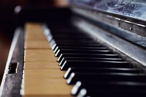 Old black piano, keys close-up, vintage musical instrument. Beautiful Blur, Selected Focus photo