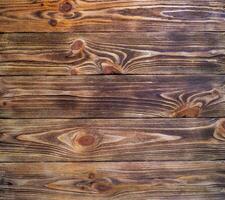 Dark old brown wooden pine background. Texture. View from above. Unprocessed boards. photo