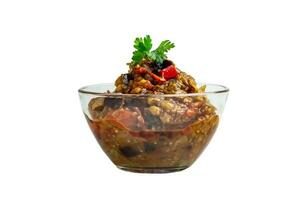 Popular vegetable dish of the world cuisine in a glass bowl, isolate, ajapsandali, pincher, stewed vegetables, eggplant caviar. Main ingredients, eggplant, tomatoes, bell peppers, garlic. photo