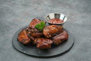 Roasted chicken wings with honey and spices photo