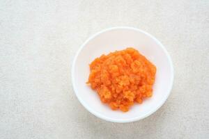 Organic carrots pulp juice, squeezed from a slow juicer, for face mask or processed into smoothie, zero waste. photo