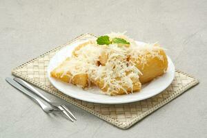 Fried cassava with cheese or singkong goreng keju, Indonesian traditional food. photo