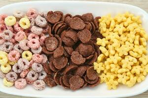 Various Cereal for breakfast, chocolate flakes, colorful flakes, and honey star. photo