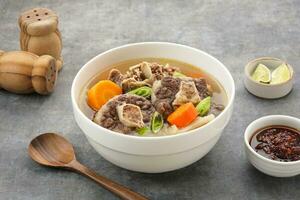 Sop Buntut or Oxtail Soup with carrot and potatoes. Indonesian traditional food photo