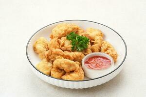 Crispy chicken fillets or ayam goreng tepung with chilli sauce photo
