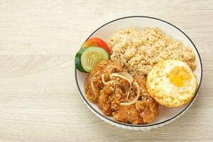 Rice Bowl with Chicken Karaage, egg and vegetables photo