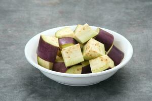 Fresh organic eggplant slice on the white bowl, close up photo