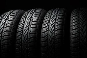 Closeup new car tires for sale at tyre store. Balck rubber car tire with modern tread at auto repair shop. Winter tires at auto repair service center. Changing tire shop. Auto service. Generative AI. photo