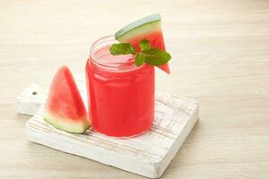 Fresh watermelon juice with mint leaf, cold pressed juice. photo