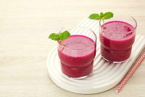 Delicious dragon fruit or pitahaya smoothie and fresh fruits with mint leaves photo