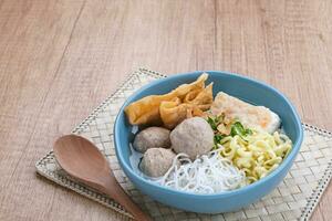 Bakwan Malang or Bakso Malang, traditional food from Malang, East Java, Indonesia. Meatballs soup served with noodles, tofu and fried dumpling photo