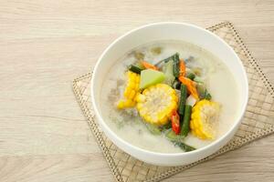 Sayur Lodeh, Indonesian traditional food. Made from corn, chayote, long beans, eggplant, cabbage and coconut milk. photo