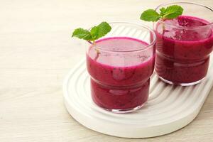 Delicious dragon fruit or pitahaya smoothie and fresh fruits with mint leaves photo