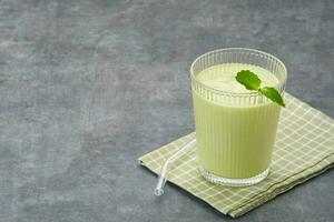 Jus Alpukat or Avocado Juice. Served in glass on dark background. photo