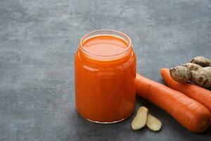 A glass of fresh juice mix carrot, apple, ginger and pineapple. Detox cleanse drink photo