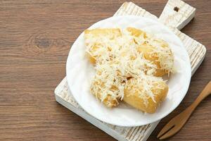 Fried cassava with cheese or singkong goreng keju, Indonesian traditional food. photo