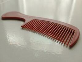 31 August 2023, small red comb to tidy up hair photo