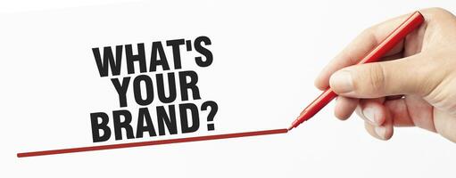 WHAT's your brand made with red marker and hand on white background photo