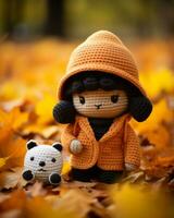 a crocheted doll with a panda bear in the leaves generative ai photo