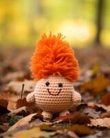a crocheted doll with orange hair sitting in the leaves generative ai photo