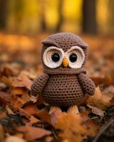 a crocheted owl sitting in the leaves generative ai photo