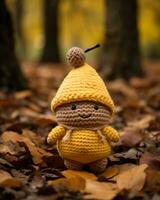 a crocheted yellow hat is sitting in the leaves generative ai photo