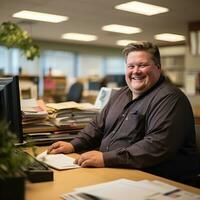 a smiling man sits at his desk in an office generative ai photo