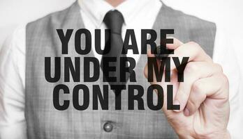 YOU ARE UNDER MY CONTROL word made by marker and hand photo