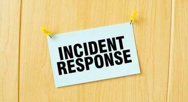 INCIDENT RESPONSE sign written on sticky note pinned on wooden wall photo