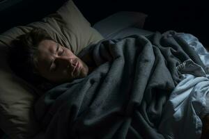 a man is sleeping in bed with a blanket generative ai photo