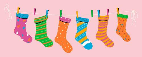 Baby socks with textures and patterns on a rope with colored clothespins. Vector illustration