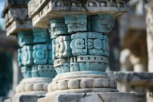 a close up of two stone pillars with blue and green designs on them generative ai photo