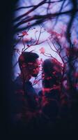 un hombre y mujer son en pie en frente de un árbol con rojo hojas generativo ai foto